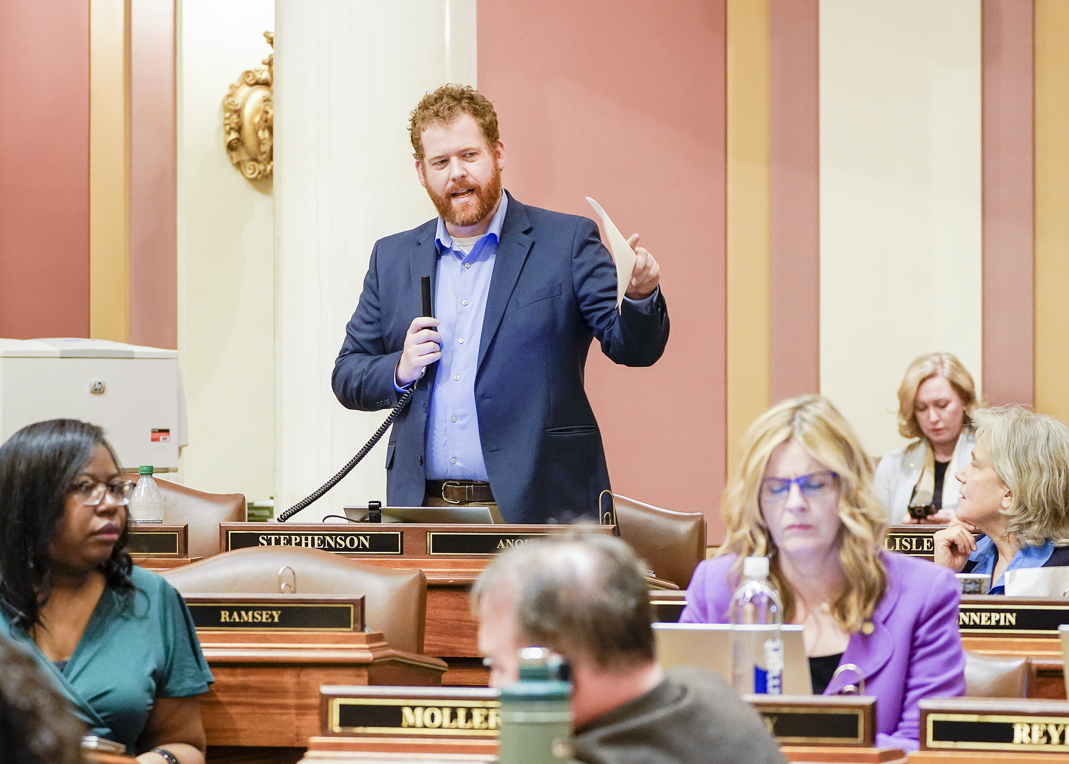 Rep. Zack Stephenson presents the commerce conference committee report on the House Floor May 17. (Photo by Andrew VonBank)